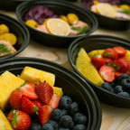 Meal prep containers filled with healthy vegetables and fruits